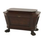A Regency mahogany wine cooler,of sarcophagus shape with panelled sides on paw feet,76cm wide47cm