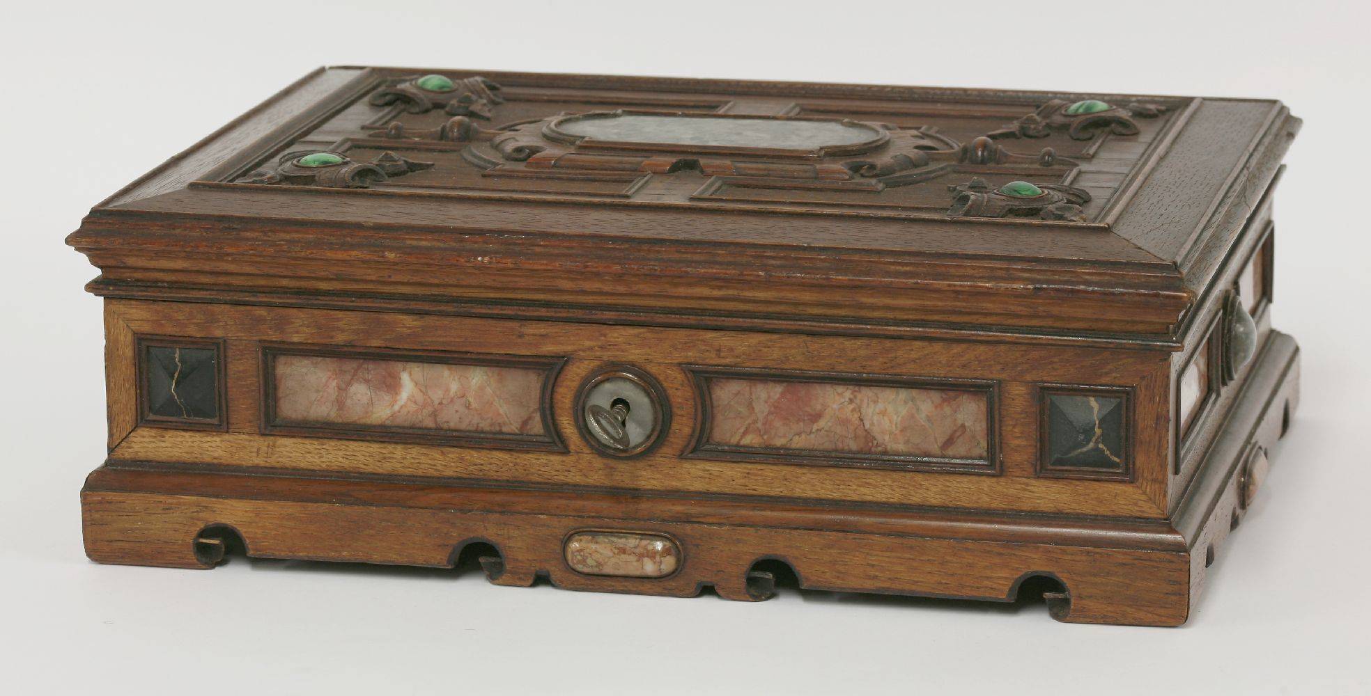 A Victorian oak casket,the panelled lid with crisply carved decoration and a central inlaid marble