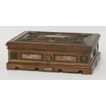 A Victorian oak casket,the panelled lid with crisply carved decoration and a central inlaid marble