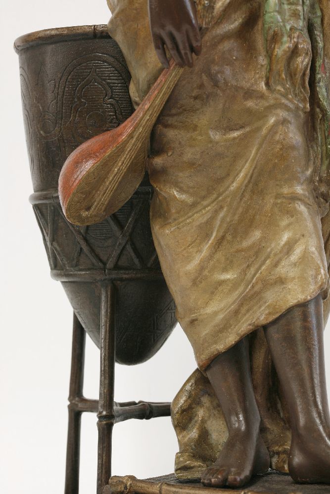 A spelter figure of an Arab girl,standing beside a brazier holding a lute and a dish, signed 'L - Image 5 of 5