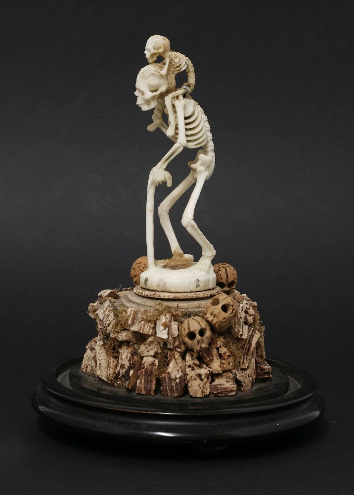 A bone and cork group,late 19th century, depicting a skeleton holding a walking stick, with a - Image 3 of 4