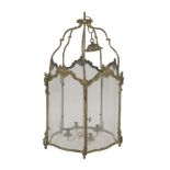 A good brass hall lantern,the scrolled brackets supporting six serpentine glass panels,89cm high