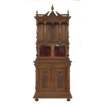 A French walnut side cabinet,in the manner of Eugene Biollet de-Luc, with crisply carved decoration,