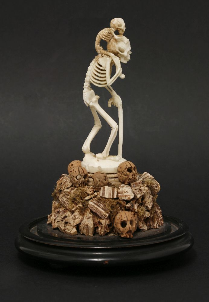 A bone and cork group,late 19th century, depicting a skeleton holding a walking stick, with a - Image 4 of 4