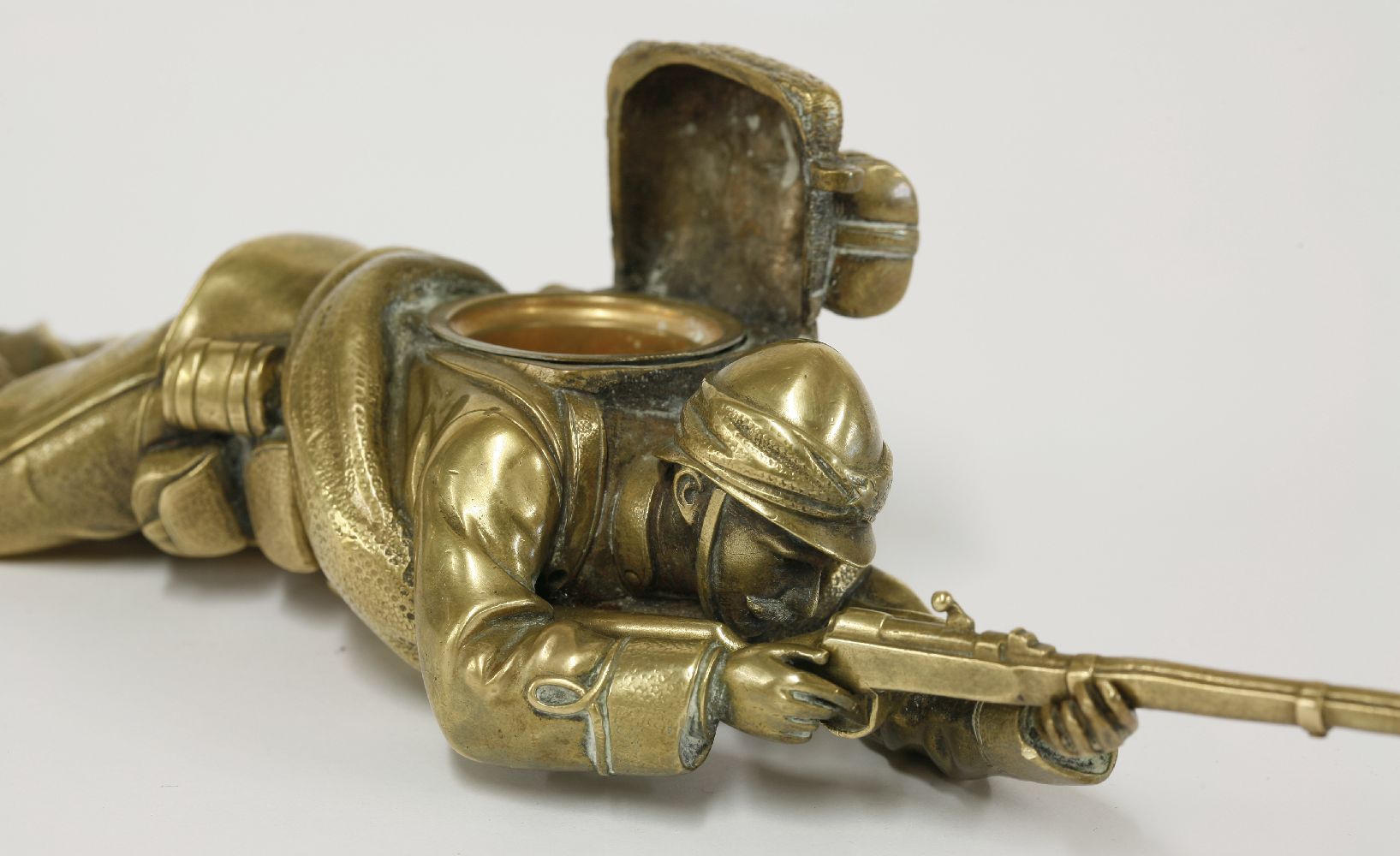 A brass inkwell,c.1900, in the form of a soldier, probably French, lying on his stomach aiming his - Image 4 of 4