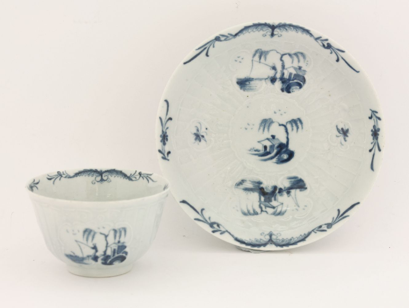 A rare Worcester blue and white Tea Bowl and Saucer,c.1755-1770, embossed with strap flutes and