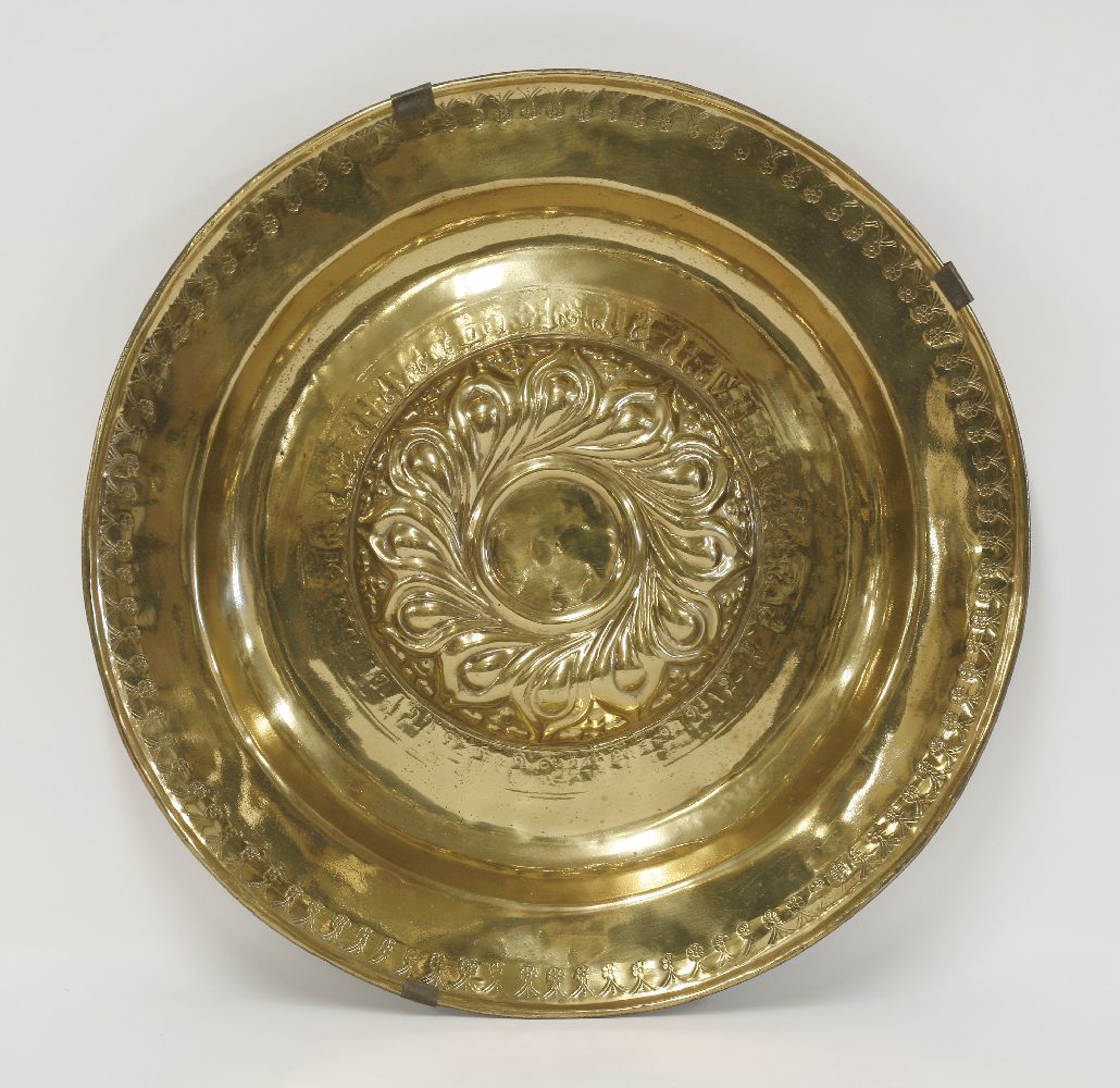 A brass alms dish,Nuremberg, 16th century, the central boss with whorls, partly separated with