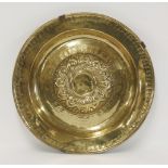 A brass alms dish,Nuremberg, 16th century, the central boss with whorls, partly separated with