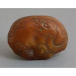 A good amber Cabochon, probably Ming, 15th century, carved in low relief with a chilong, the