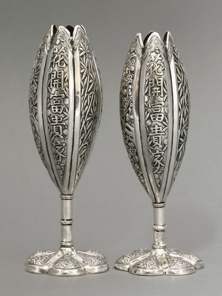 A pair of silver Solifleur Vases, c.1880, each of tall form, well chased with The Three Friends,