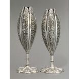 A pair of silver Solifleur Vases, c.1880, each of tall form, well chased with The Three Friends,