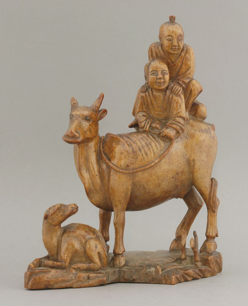 An attractive hardwood Group, 18th century, of two boys, one riding piggyback on his companion and