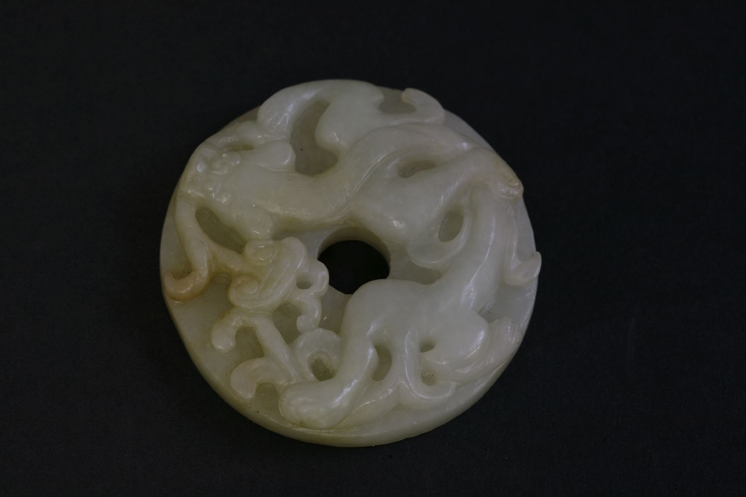 A jade Bi Disc, 20th century, carved with a chilong, a lingzhi in his mouth, the underside with