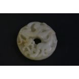 A jade Bi Disc, 20th century, carved with a chilong, a lingzhi in his mouth, the underside with