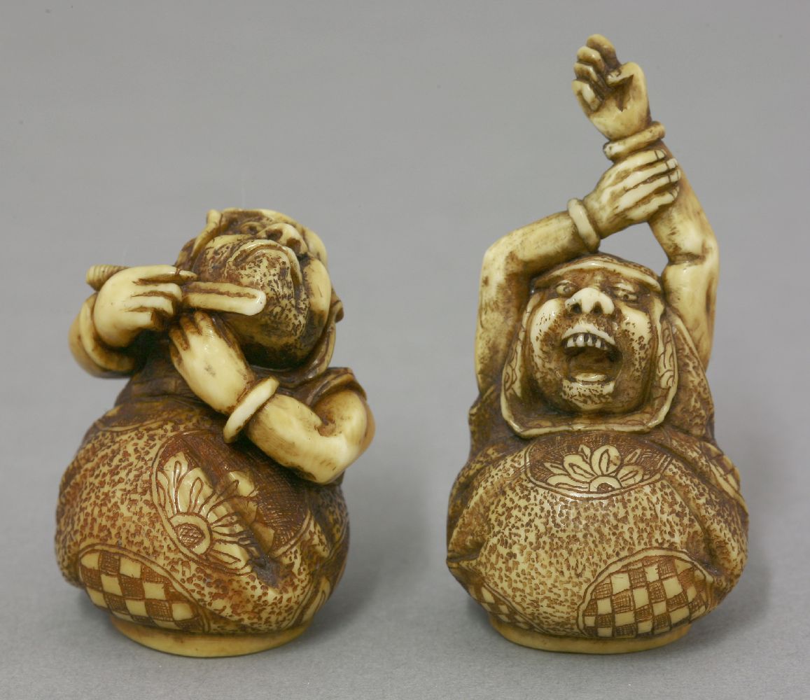 A rare and fine pair of ivory Netsuke, mid 19th century, one of Daruma stretching his arms above his