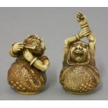 A rare and fine pair of ivory Netsuke, mid 19th century, one of Daruma stretching his arms above his