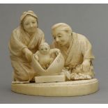 An attractive ivory Okimono, c.1880, of Momotaro, the Peach Boy arising from the fruit watched by