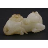 A fine white jade Horse, probably 18th century, resting with turned head, its back carrying