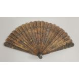 A finely carved Canton tortoiseshell brisé Fan, c.1810, with numerous figures at various pursuits in