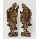 A pair of wood Fishermen, late 19th century, each carved with creel, fish or oar, the eyes and teeth