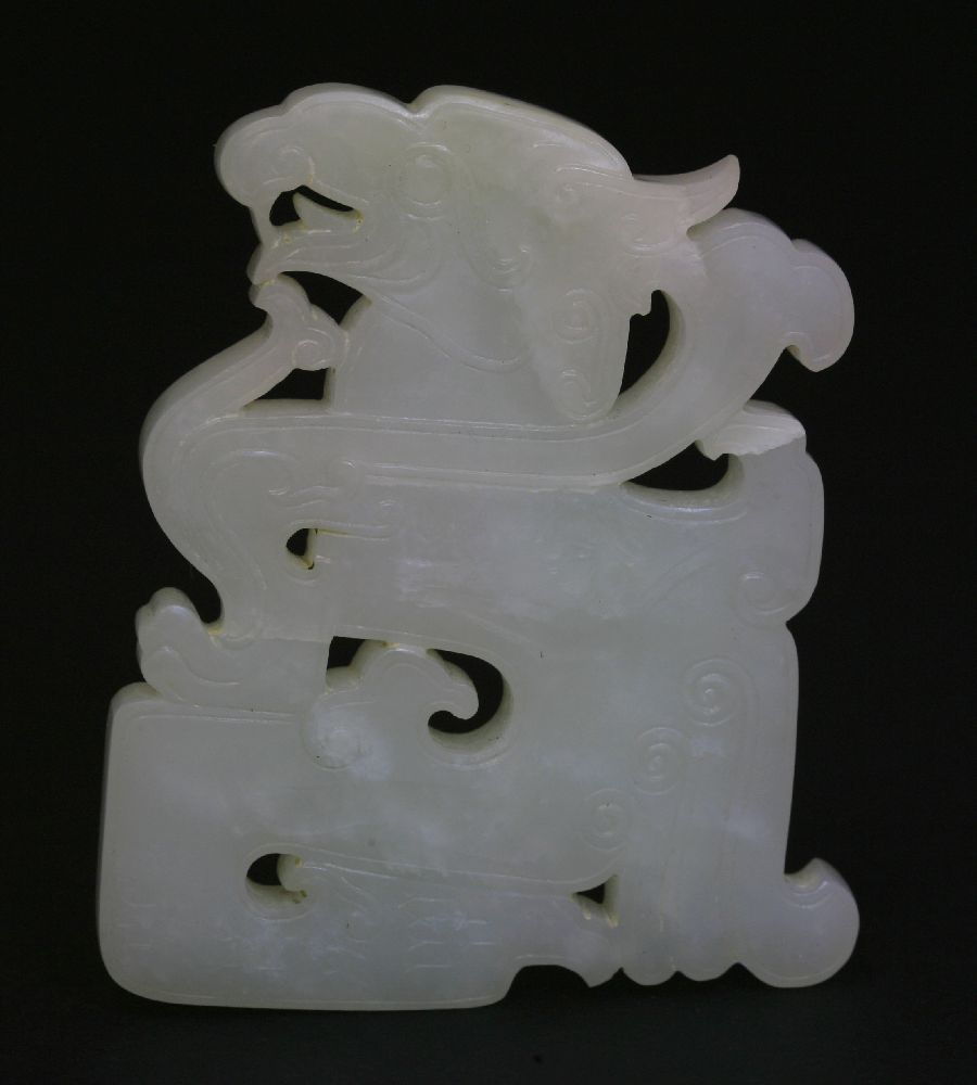 A well carved white jade Dragon, 18th century, with finely incised lines and pierced details,