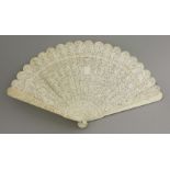 A Canton ivory double-sided brisé Fan, c.1860, intricately carved with numerous figures around a