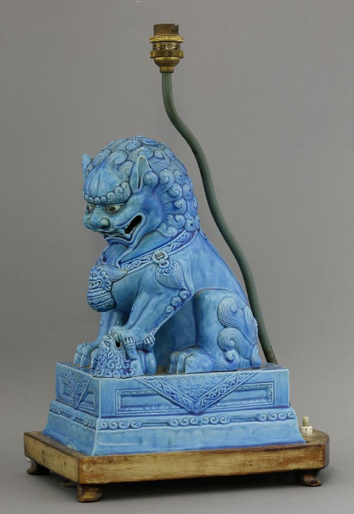 A turquoise glazed Buddhist Lion and Cub, early 20th century, on a rectangular flared base, fixed