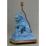 A turquoise glazed Buddhist Lion and Cub, early 20th century, on a rectangular flared base, fixed