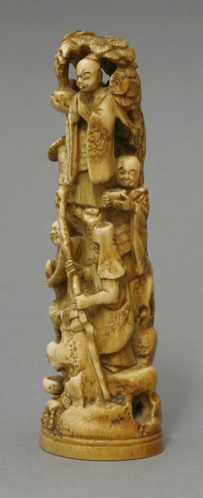 An ivory Okimono, c.1870, carved as eight rakan on a high rock beneath a pine tree, signed Gyokuzan, - Bild 2 aus 5