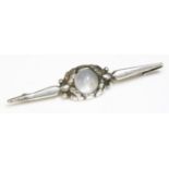 A silver moonstone bar brooch,by Georg Jensen, No. 117, with a circular cabochon moonstone set to