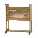 An Arts and Crafts oak magazine rack,inset to the front with a copper panel embossed with 'A Place