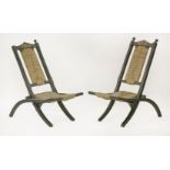 A pair of Aesthetic ebonised and painted folding chairs,with rush seats and backs (2)