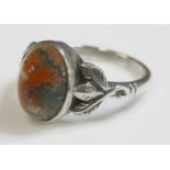 An Arts and Crafts moss agate ring,attributed to Bernard Instone, with an oval cabochon moss