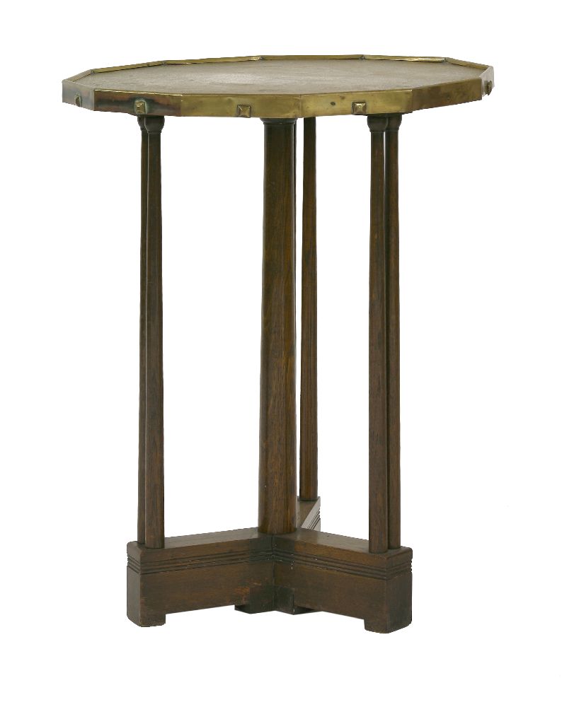 A brass and oak side table,the twelve-sided top with a hatched surface and square-headed bosses to