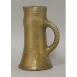 An Elton 'Sunflower' pottery jug,with a crackled gold glaze, the rim with horizontal bands,