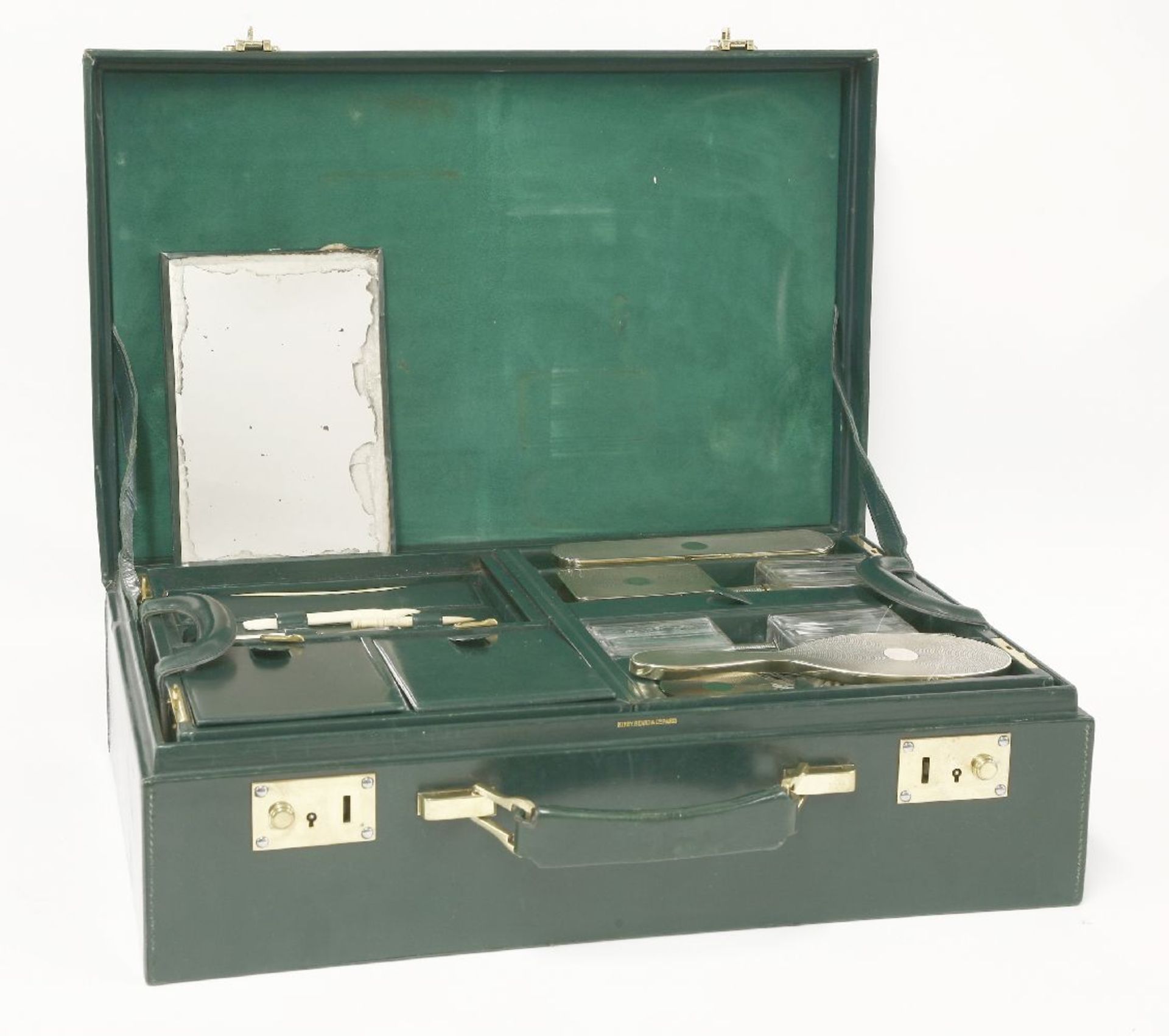 A green leather dressing case,the fitted interior with French silver-gilt mounted glass jars and