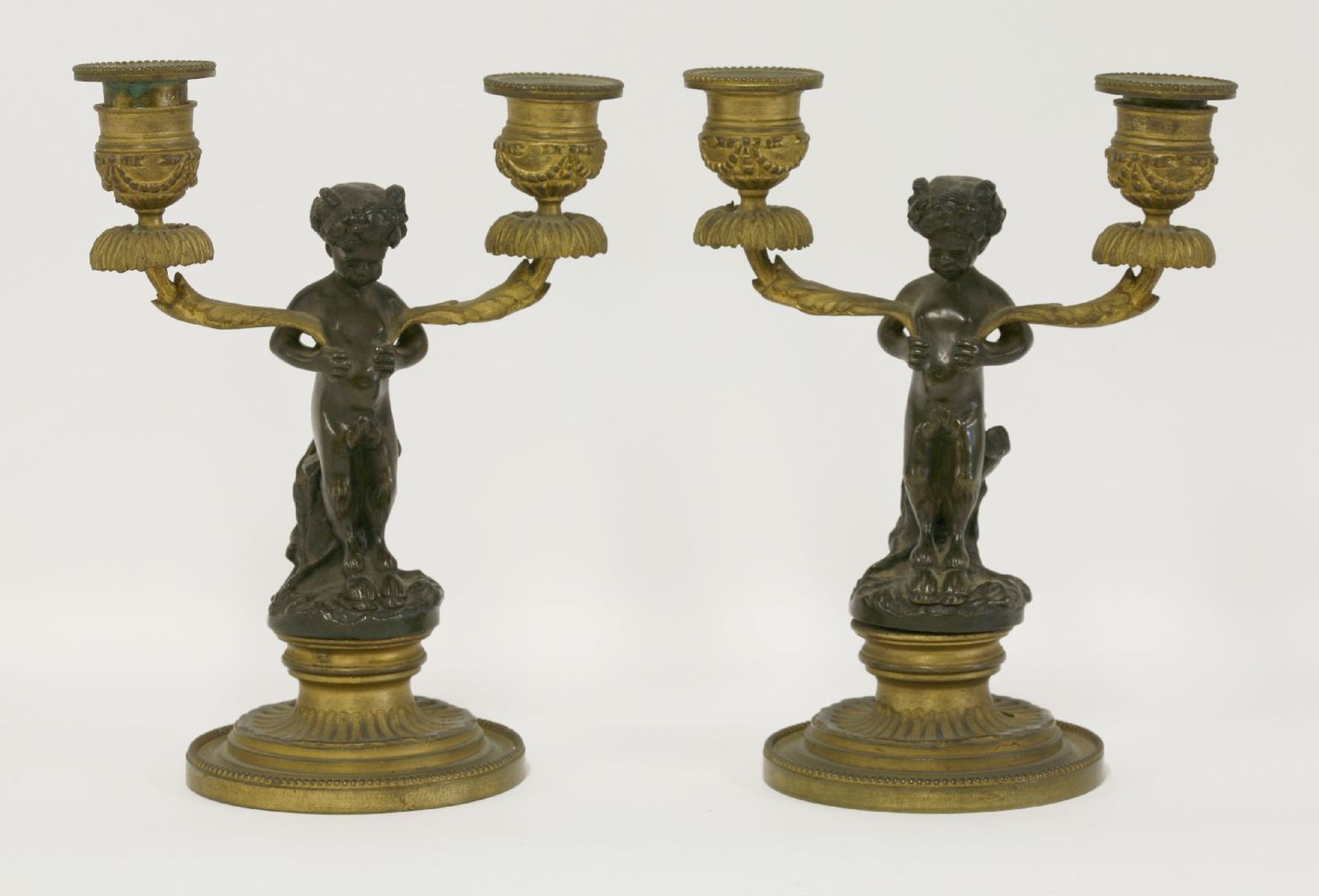 A pair of bronze ormolu twin branch candelabra,19th century, the sconces decorated with swags and