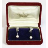 A pair of cased cultured pearl and diamond drop earrings by Mikimoto,with a polished and textured