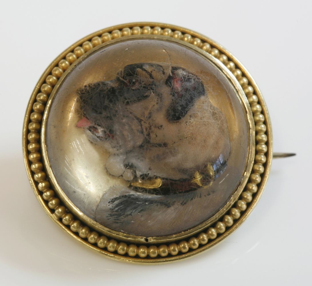A Victorian gold mounted, reverse painted crystal 'bull mastiff' brooch,the brooch 23mm diameter,