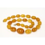 A single row graduated amber bead necklace,with graduated oval butterscotch amber beads,