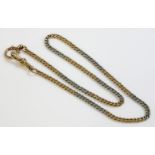 An Art Deco gold and platinum watch chain,with alternating sections of white and yellow curb