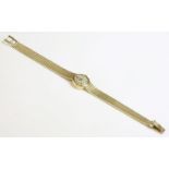A ladies' 9ct gold Omega mechanical bracelet watch,with a circular silvered dial and raised gilt and