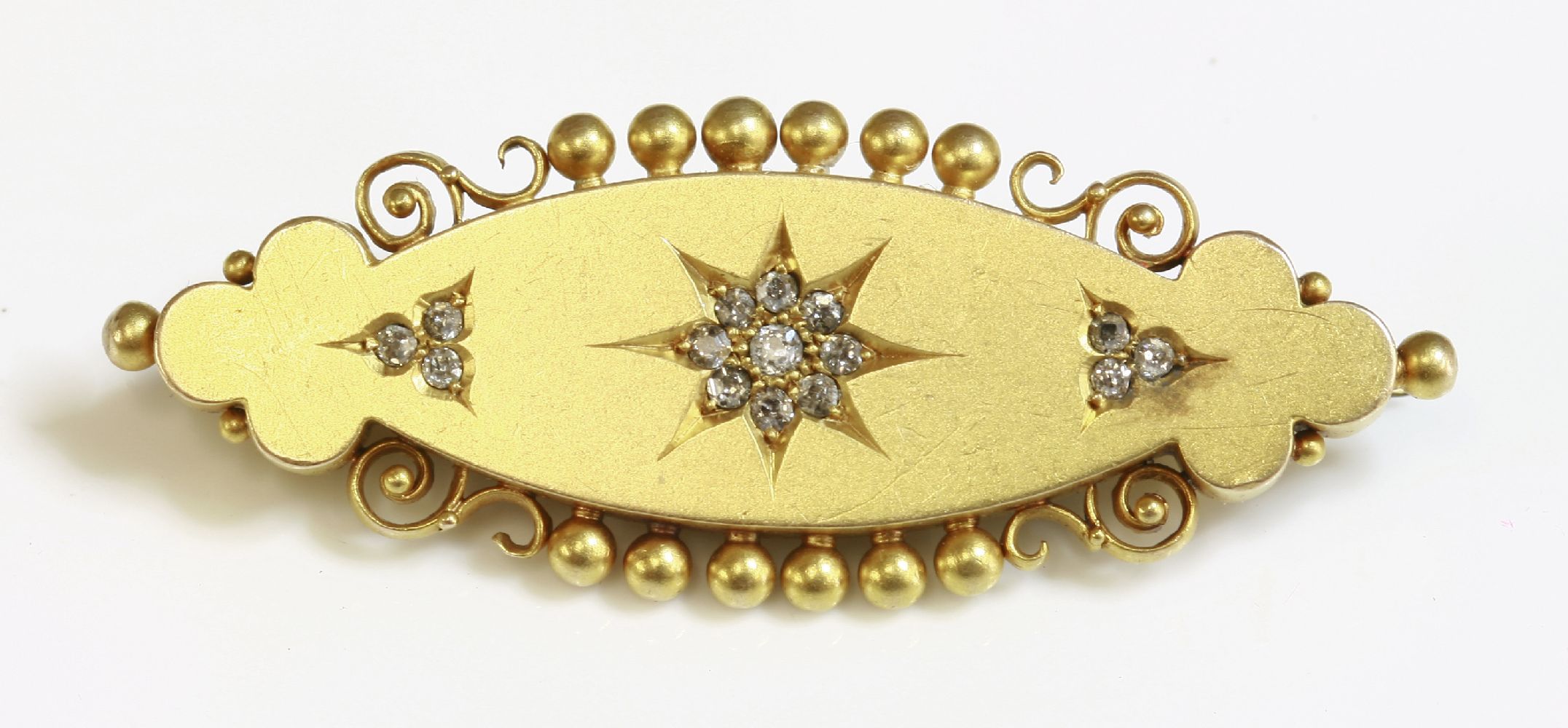 A cased late Victorian diamond set brooch,of navette form, with a trefoil at each end.  A central