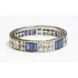 A sapphire and diamond full eternity ring,4.5mm wide, with sets of three baguette cut sapphires,