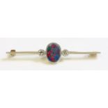 A three stone opal doublet and diamond bar brooch, c.1930,with an oval black opal doublet,