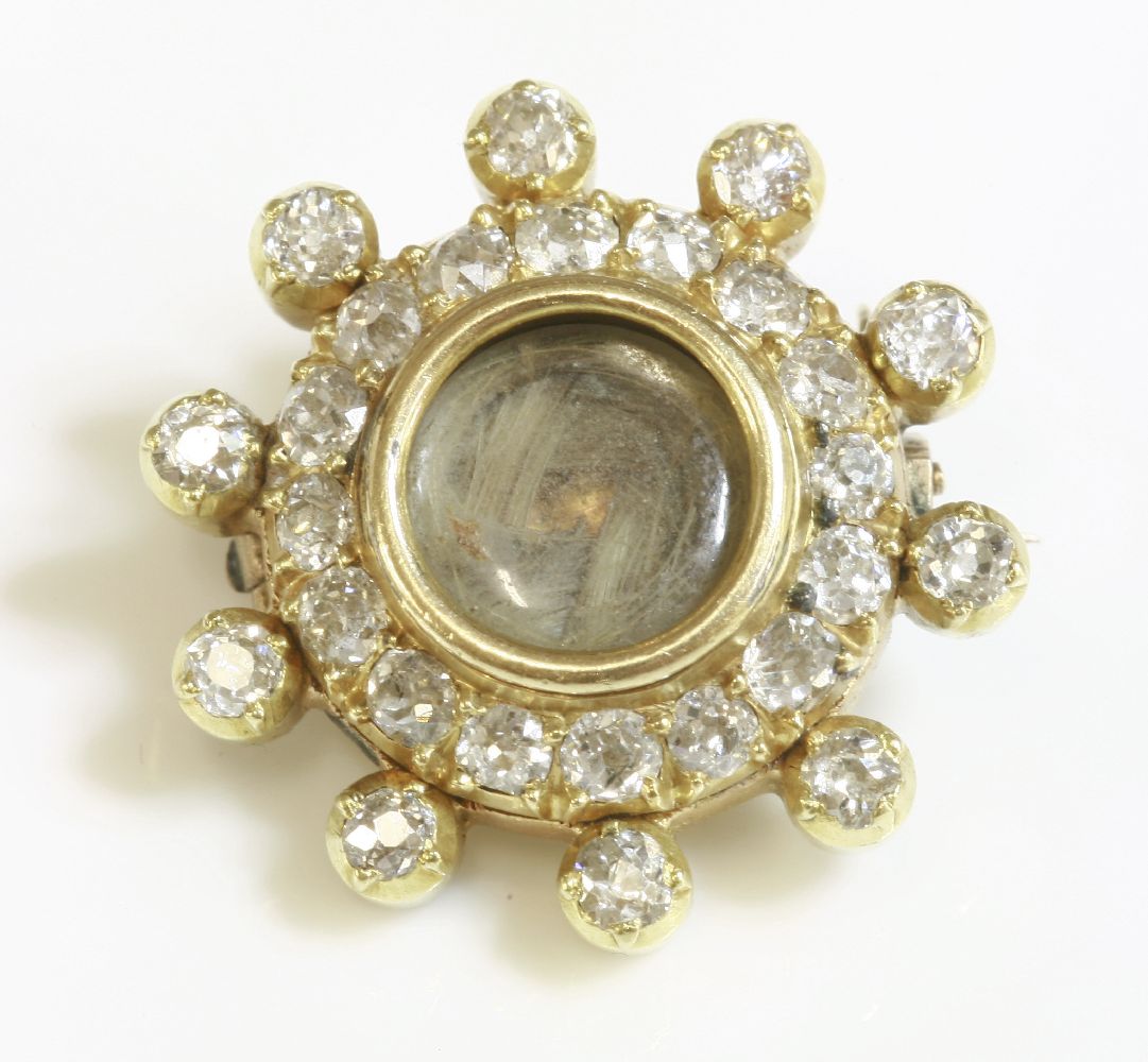 A gold and diamond set memorial brooch,with a circular glazed centre, woven hair below, to a