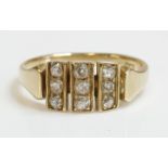 A late Victorian nine stone diamond ring,with three flat vertical divisions, each one grain set with