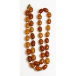 A single row amber and wooden rondelle bead necklace,with slightly graduated varicoloured oval amber