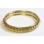 A late Victorian hinged gold bangle,with a central rope twist.  Applied gold beads to each side,