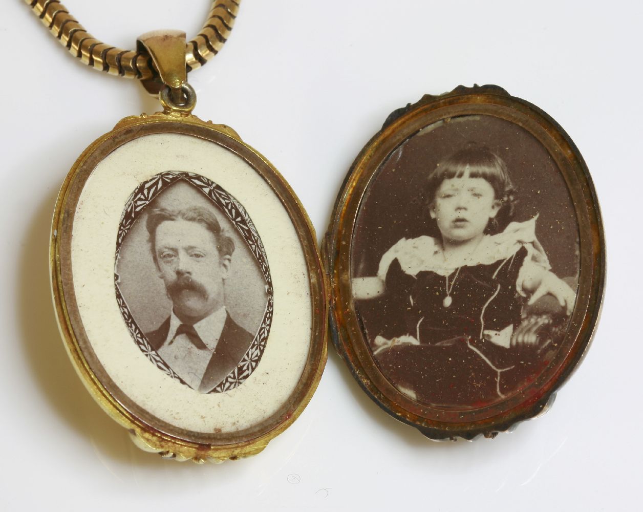 A Victorian gold locket and chain,the oval hinged locket with raised vertical bands with applied - Image 2 of 2
